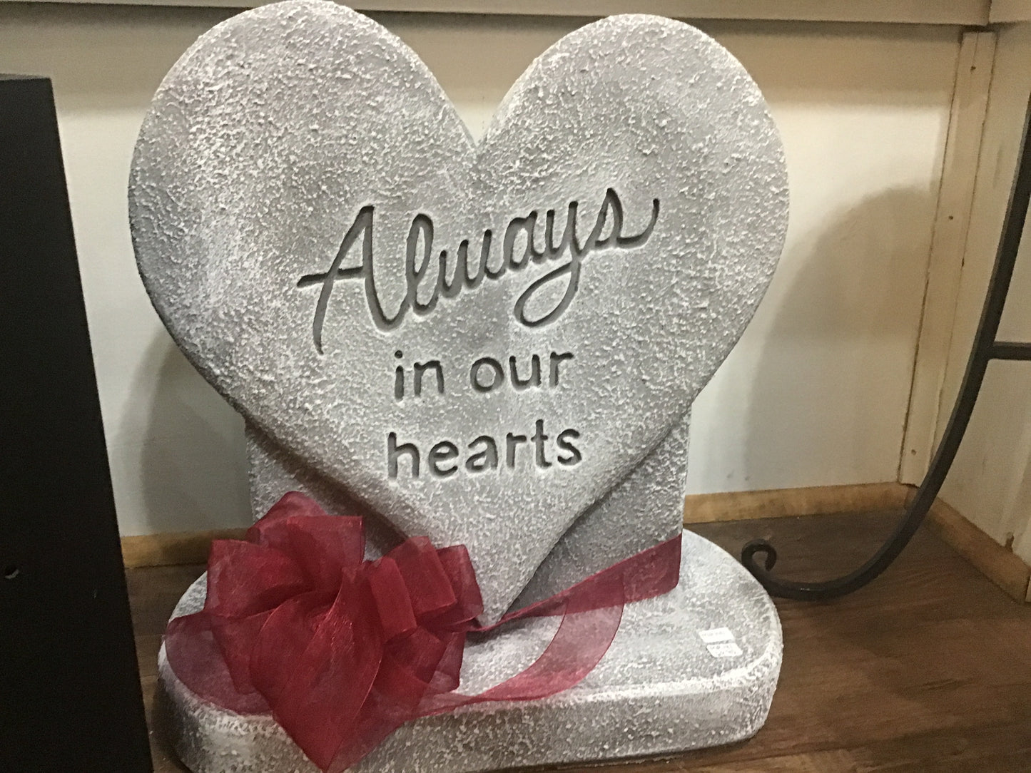 Cement heart Always in our hearts on a base