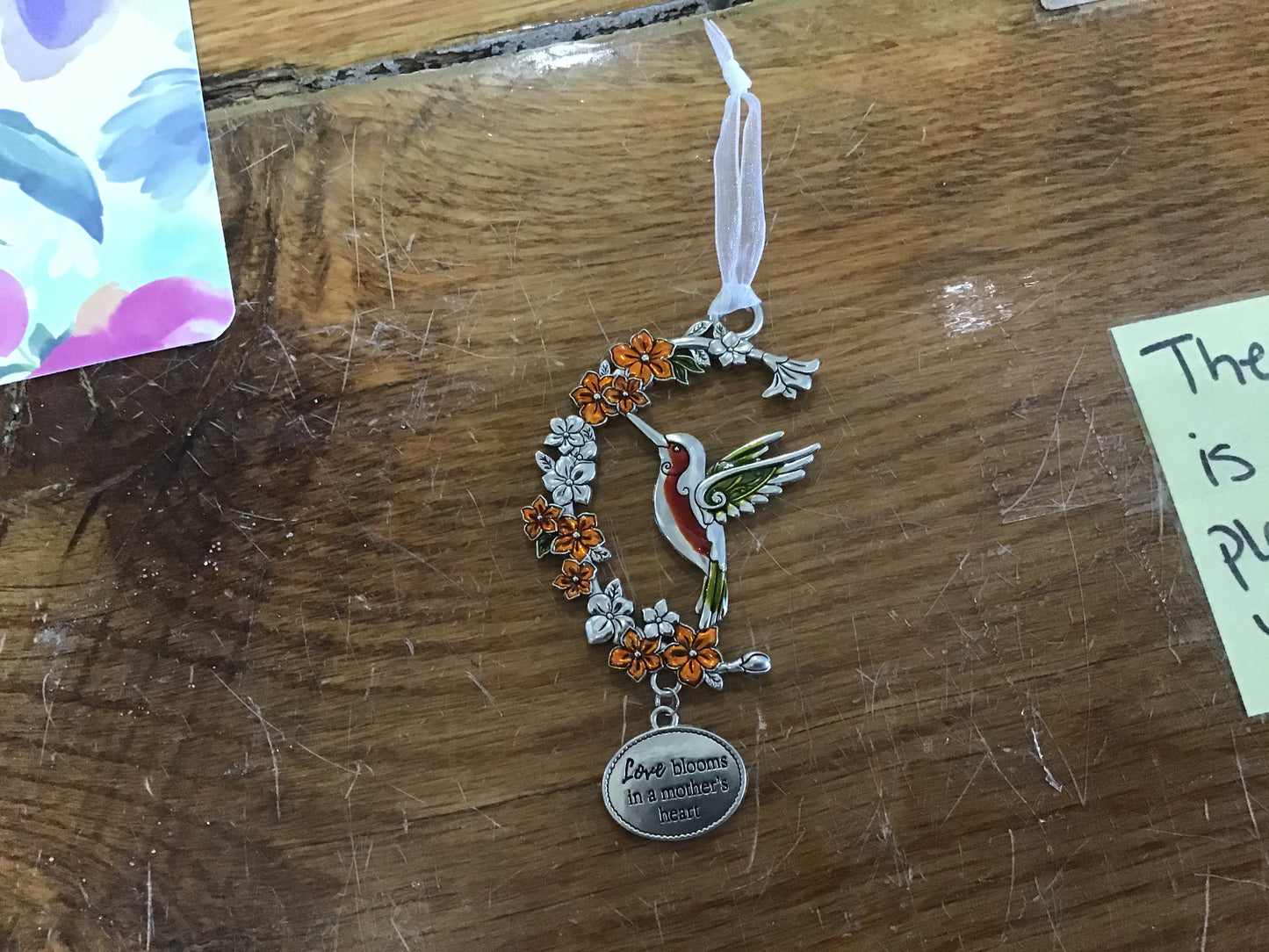 Love blooms in a mother’s heart charm