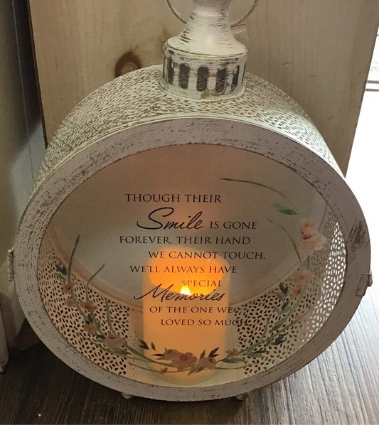 White round glass and metal lantern memorial peach flowers smile is gone