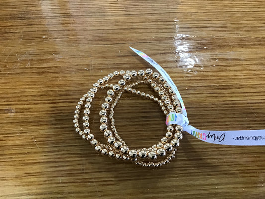Set of four delicate gold tone bracelets