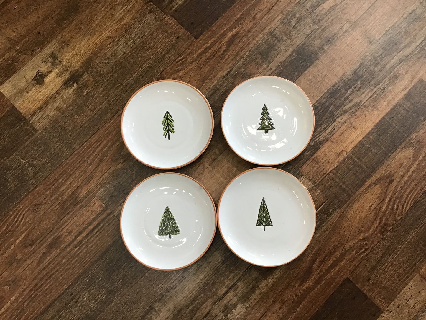 Set of four dessert plates with tree decoration on them ceramic